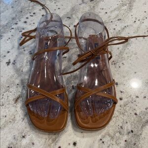 Margaux The Flat Sandal in saddle nappa leather.